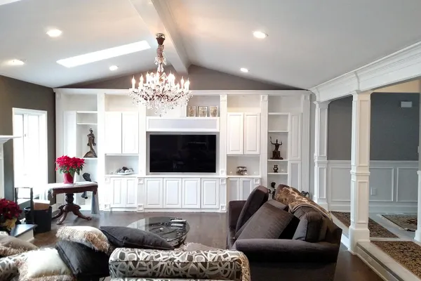 Great room with built-in entertainment wall and chandelier
